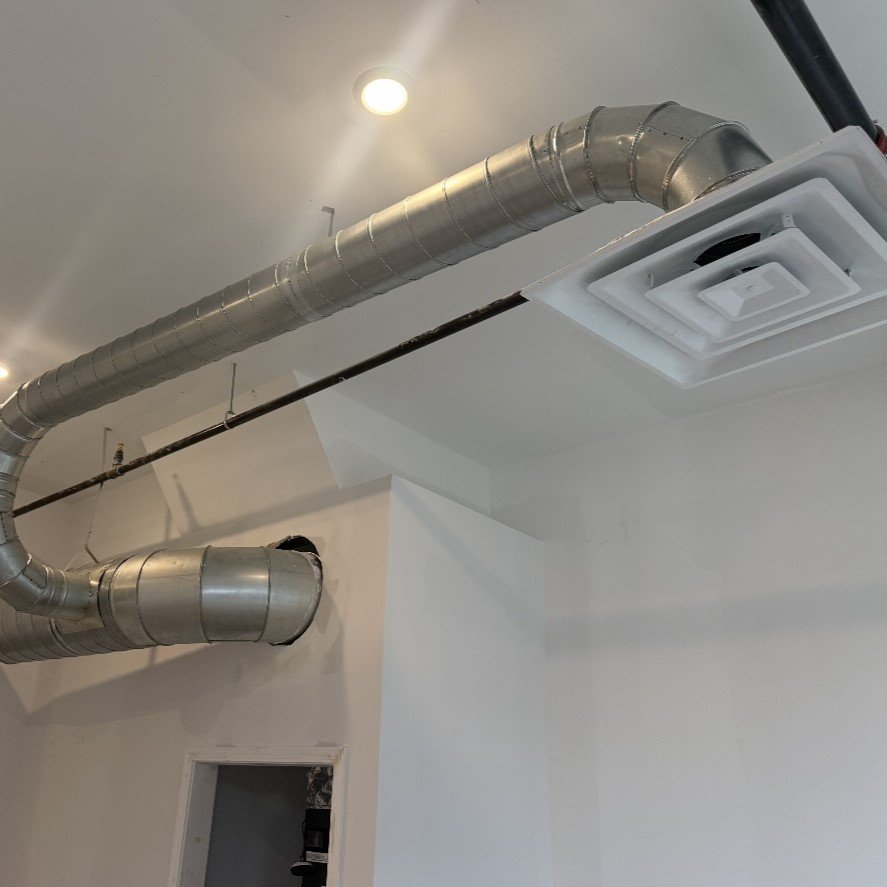 Professional Heating and Cooling technician diagnosing an issue during an AC repair service.